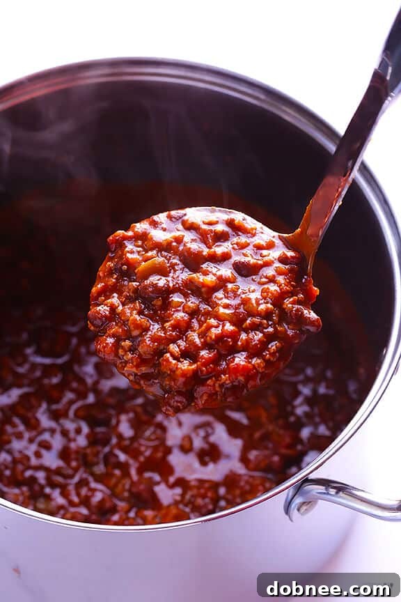 Close-up of a bowl of 5-Ingredient Easy Chili, garnished with cheese and green onions