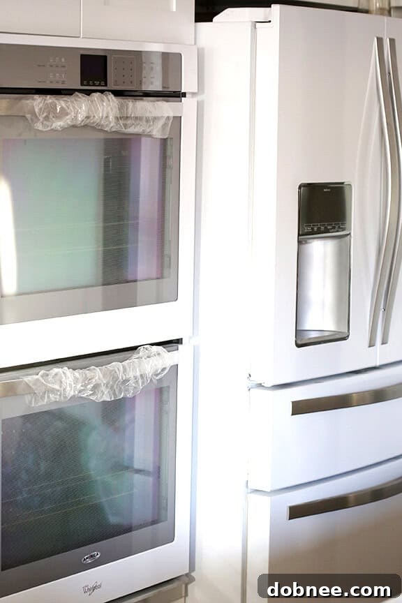 Whirlpool White Ice refrigerator and appliances installed in new kitchen.