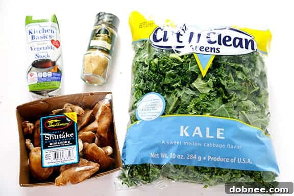 An overhead shot showcasing the vibrant ingredients for a healthy and quick ginger beef, mushroom, and kale stir-fry.