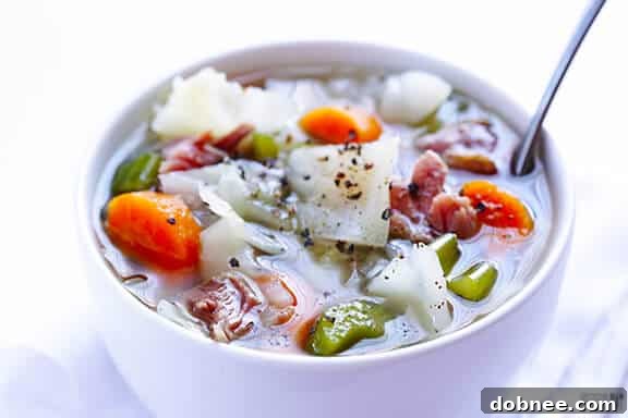 Hearty Ham and Cabbage Soup simmering in a pot