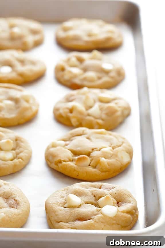 Freshly baked Caramel White Chocolate Cookies on a cooling rack