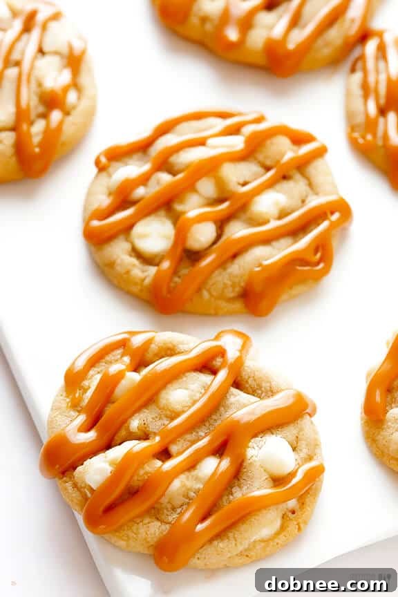Caramel White Chocolate Cookies being drizzled with caramel sauce