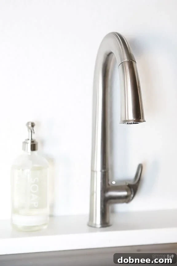 The sleek design of the Kohler Sensate touchless pull-down kitchen faucet in a stainless finish, a perfect addition to a modern kitchen.