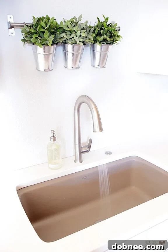 A close-up view of the Kohler Sensate touchless faucet, demonstrating its elegant design and modern features within the new kitchen.
