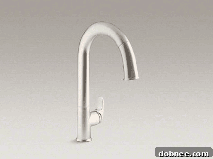 A close-up showing the seamless integration of the Kohler Cape Dory sink and Sensate faucet, highlighting their cohesive design.