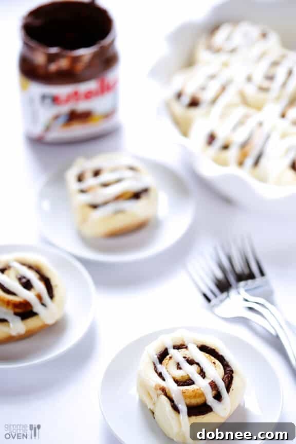 Plated 1-Hour Nutella Cinnamon Rolls with cream cheese frosting, ready to serve