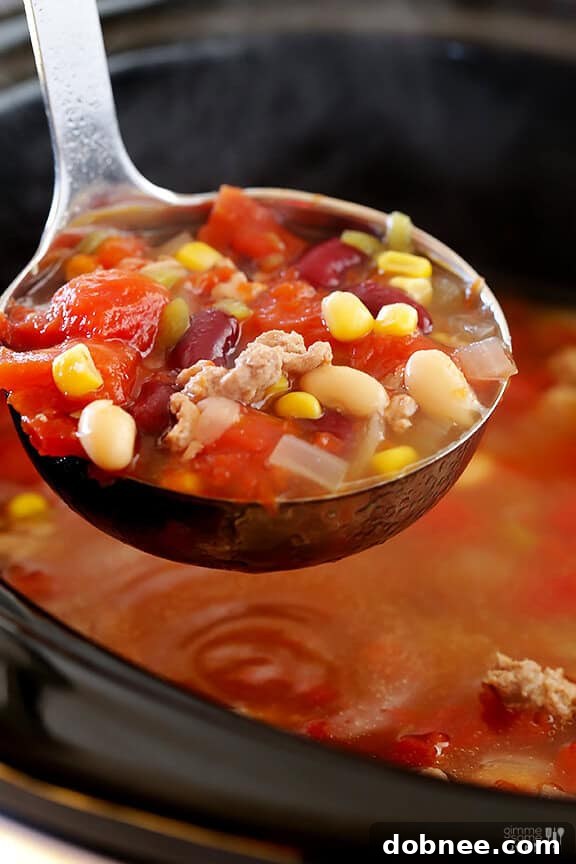 Close-up of a bowl of Skinny Slow Cooker Taco Soup with toppings