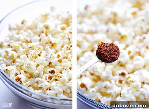 Freshly popped popcorn being seasoned with taco spice