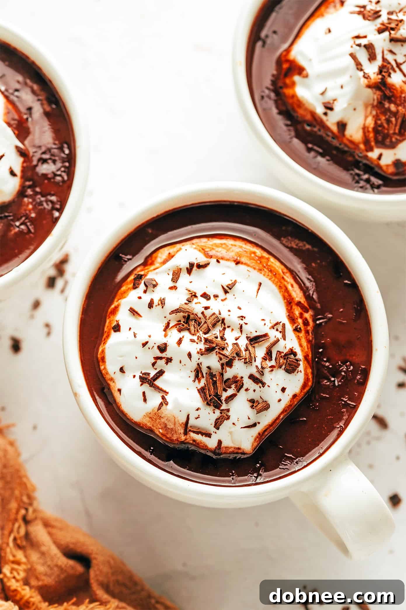 Cozy Cocoa Comfort 2 A steaming mug of homemade hot chocolate, garnished with whipped cream and chocolate shavings.