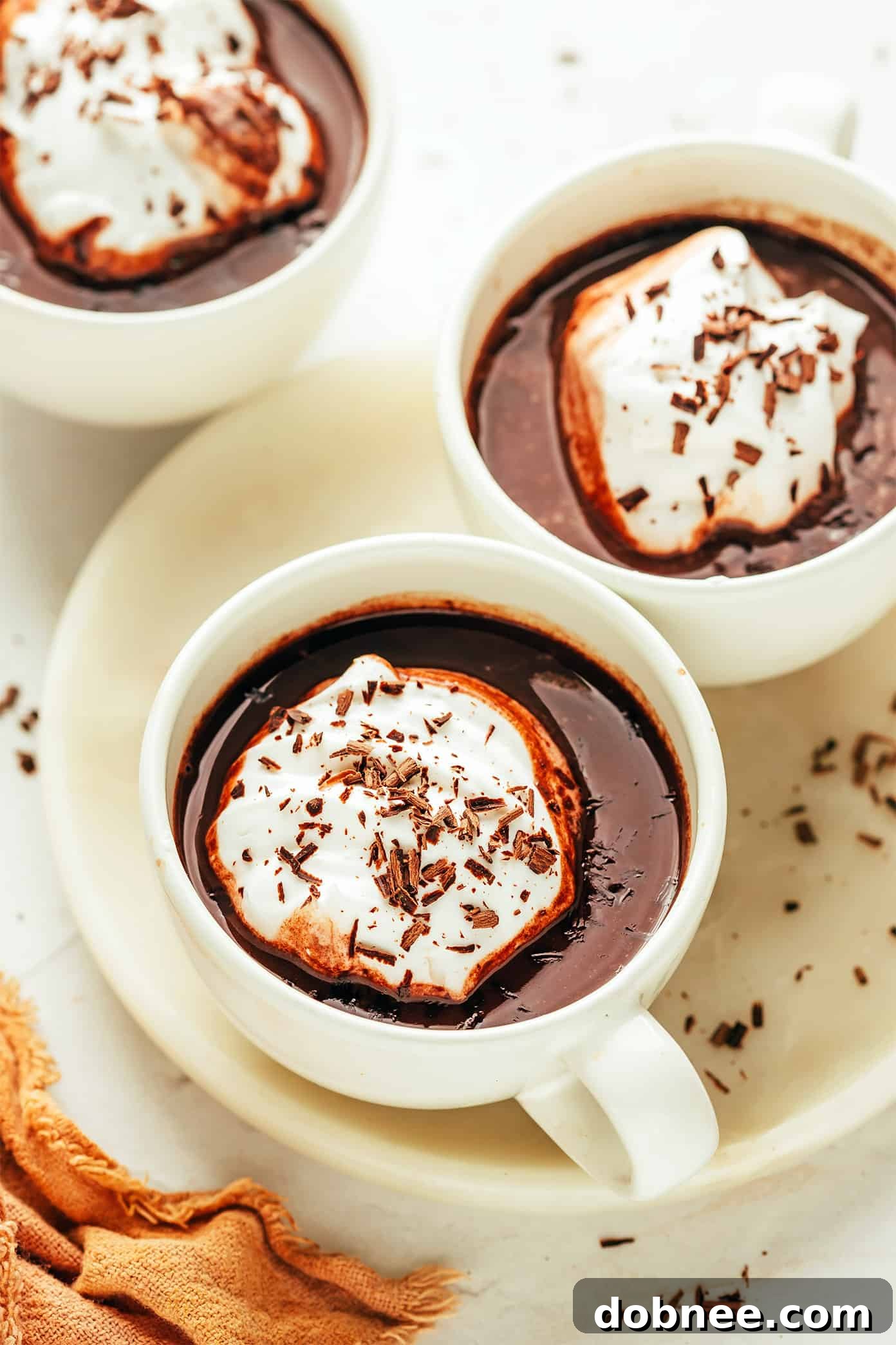 Cozy Cocoa Comfort 5 Four mugs of hot chocolate with various toppings, showcasing different variations.