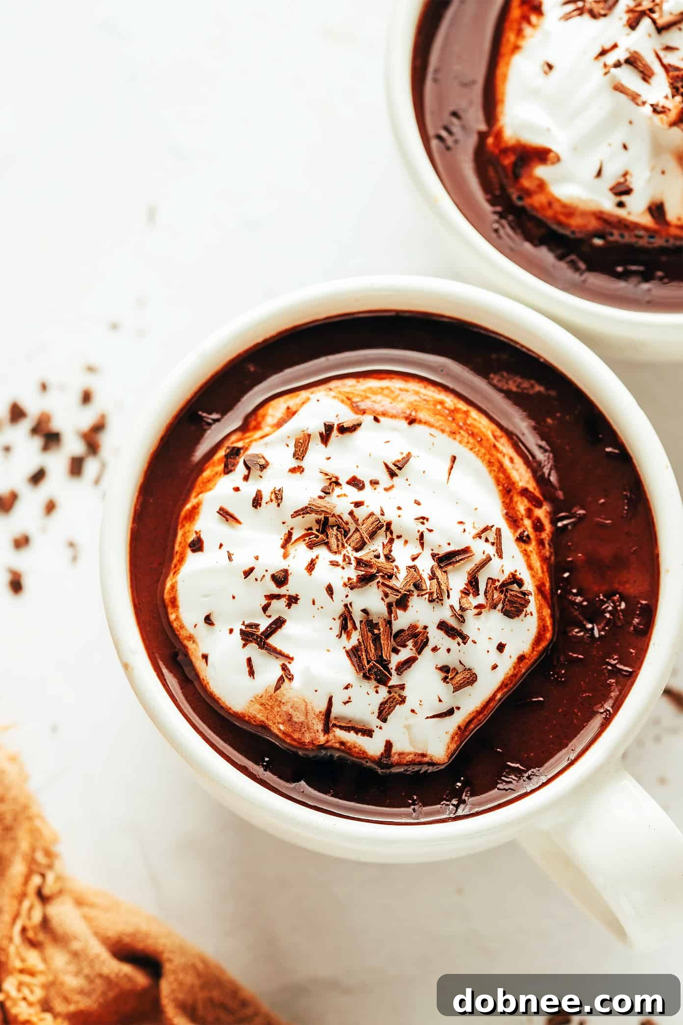 Cozy Cocoa Comfort 6 Five mugs of homemade hot chocolate, some with whipped cream and sprinkles, others with marshmallows.