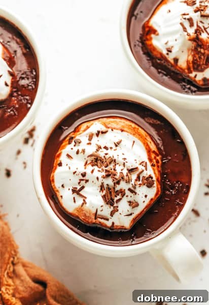 A mug of homemade hot chocolate with whipped cream, ready to be enjoyed.