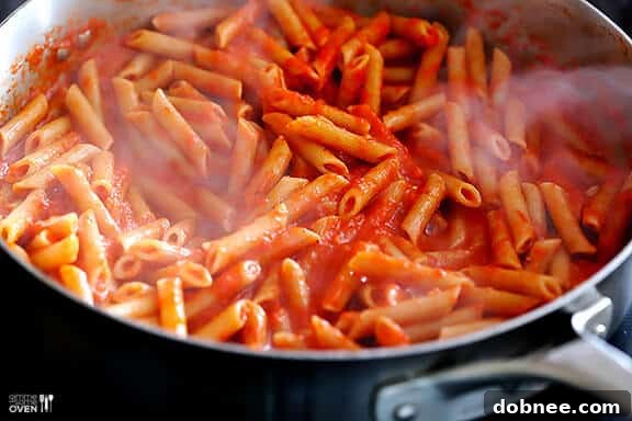 Bright Red Pasta Sauce Tossing Pasta with Red Pepper Sauce