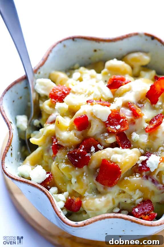 Close-up of Blue Cheese Bacon Macaroni and Cheese, garnished with extra bacon and blue cheese.