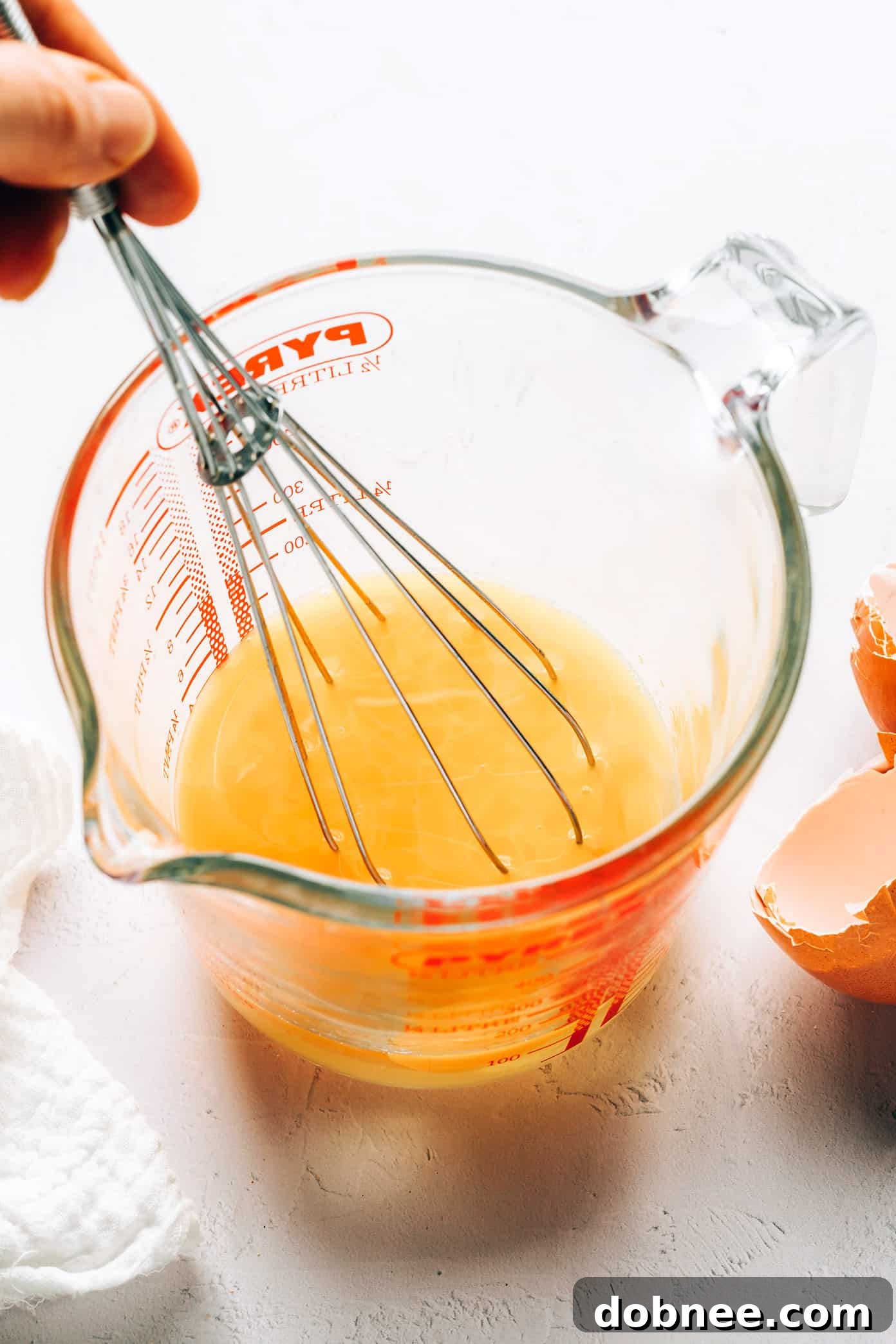 All the fresh ingredients for egg drop soup laid out on a wooden board.