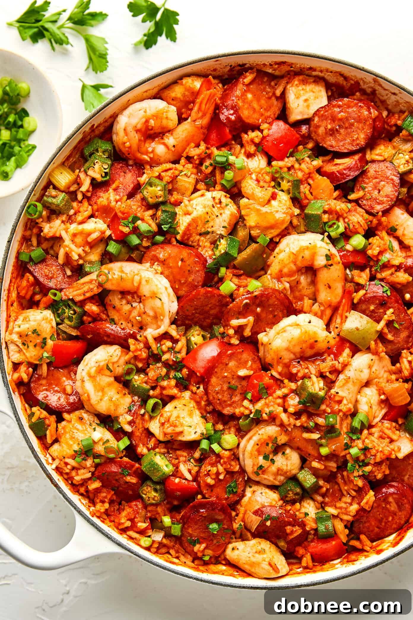 A bowl of hot, flavorful Jambalaya ready to be served, garnished with fresh herbs.