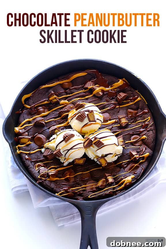 Close-up of the finished Chocolate Peanut Butter Skillet Cookie with melted toppings.