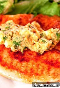 A beautifully presented serving of tilapia with cilantro-lemon butter, featuring the fish, a dollop of butter, and fresh herbs, ready for a meal.