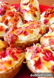 Close-up of fluffy Blue Cheese Twice-Baked Potatoes topped with crumbled bacon and melted cheddar cheese.