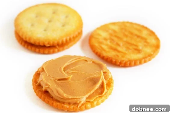 Close-up of a stack of chocolate-covered Ritz and peanut butter cookies, showing the perfect coating and crunchy texture.