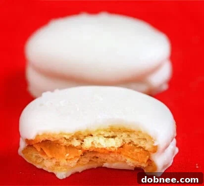 Stacked white chocolate covered Ritz and peanut butter cookies with sprinkles