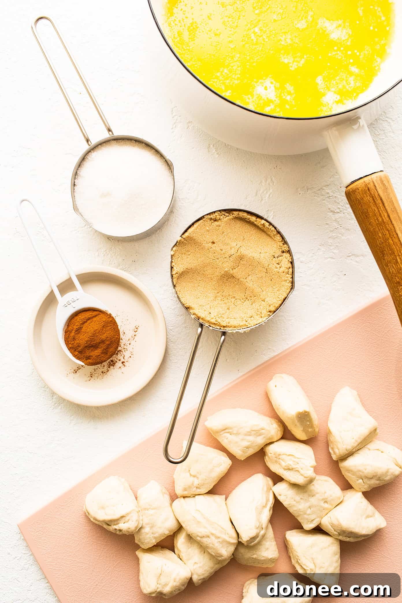 Monkey bread dough pieces coated in cinnamon sugar, ready to be layered in a bundt pan