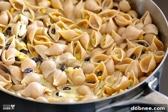 Evaporated milk mixture poured over pasta and vegetables