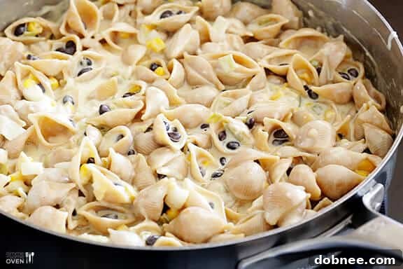 Melted cheese stirred into Mexican Mac and Cheese