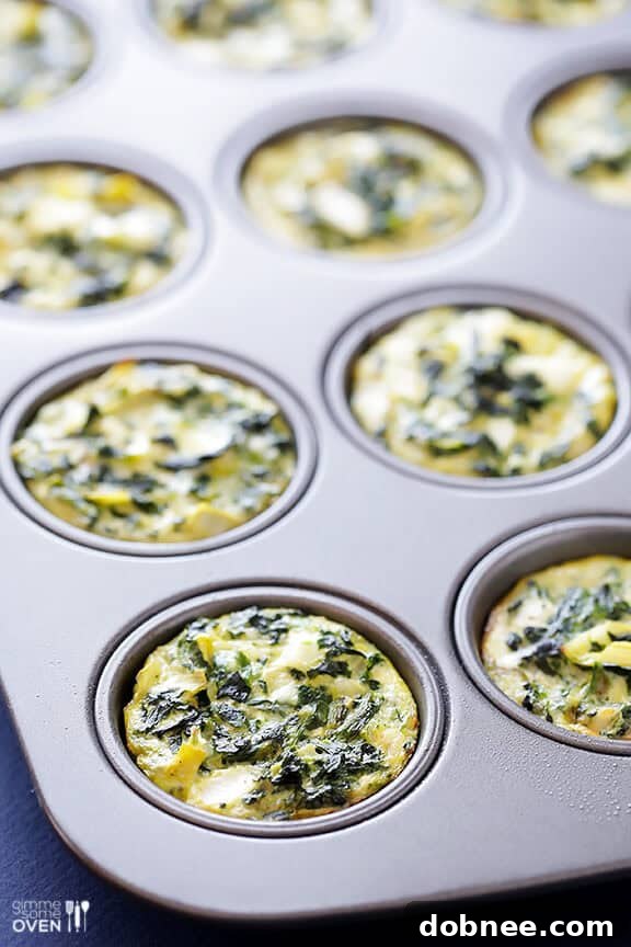 Spinach Artichoke Quiche Cups baking in the oven.