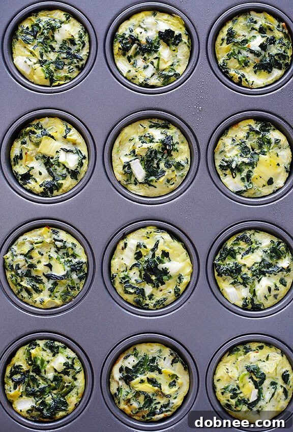 Serving freshly baked Easy Spinach Artichoke Quiche Cups.