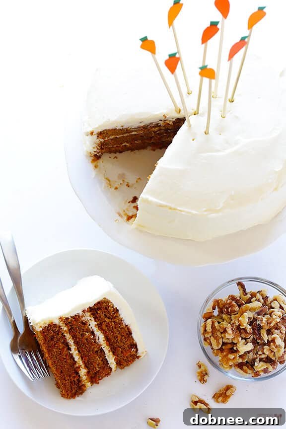 Deliciously moist Vegan Gluten-Free Carrot Cake with a rich, creamy vegan 'cream cheese' frosting. Perfect for any celebration, this plant-based and gluten-free recipe from gimmesomeoven.com is a true crowd-pleaser.