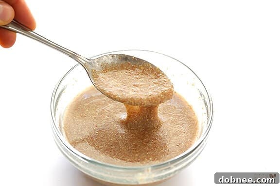 Close-up of the delicious Vegan Gluten-Free Carrot Cake, highlighting the smooth and creamy vegan 'cream cheese' frosting.