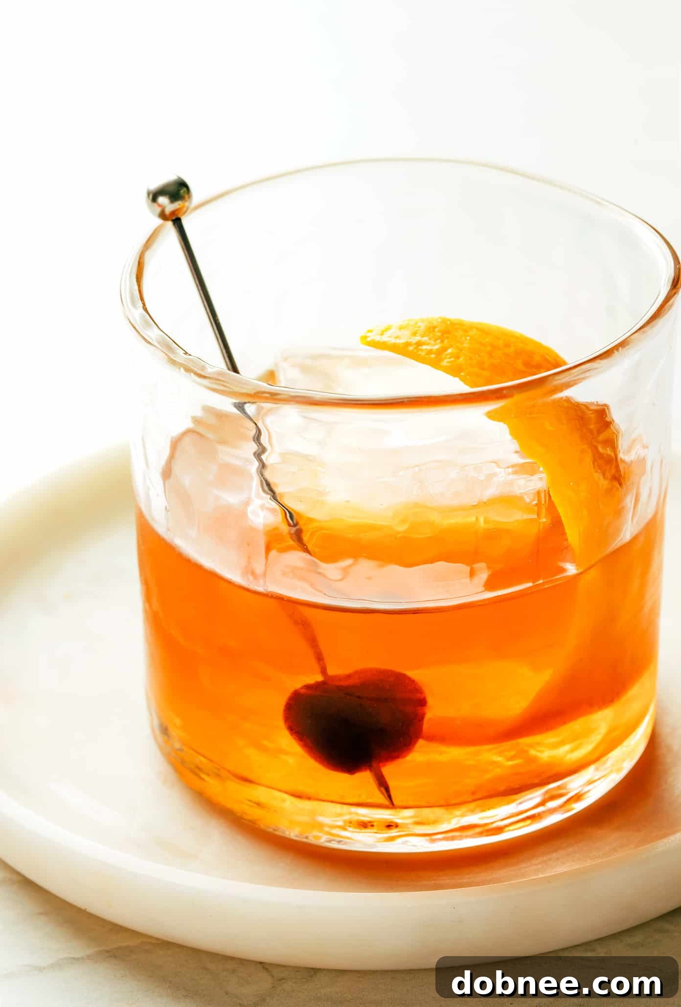 A freshly made Old Fashioned cocktail in a clean lowball glass, ready to be enjoyed, with a blurred background.