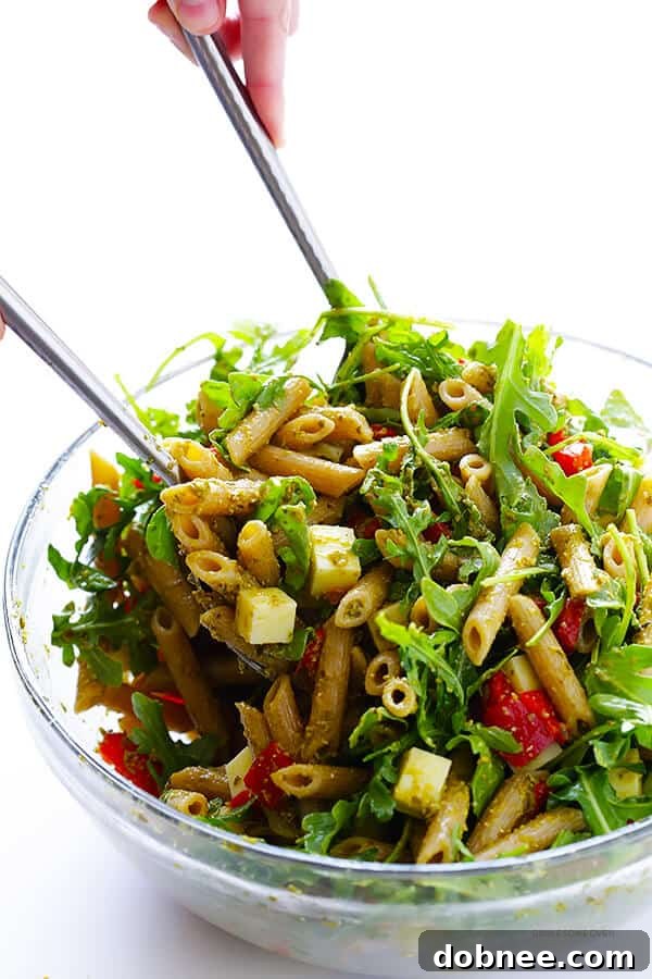 Tossing together the simple ingredients for a delectable 5-Ingredient Pesto Pasta Salad. Fast, fresh, and full of flavor. | dobnee.com