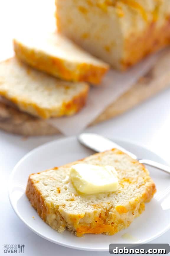 Freshly baked Garlic Cheddar Beer Bread, sliced to perfection, revealing its cheesy, aromatic interior.
