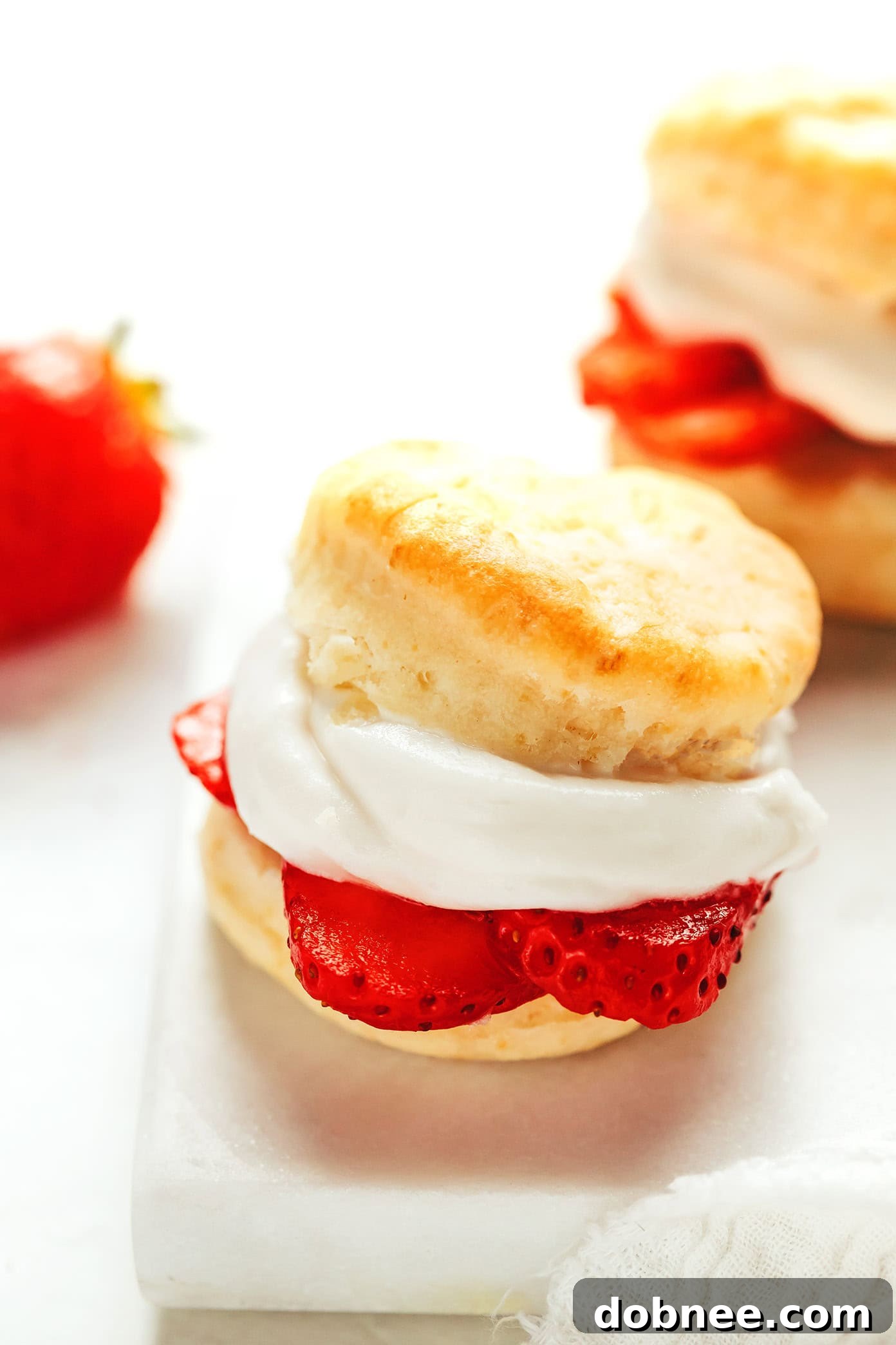 Creamy, peaks of coconut whipped cream in a mixing bowl, showcasing its light and airy texture.