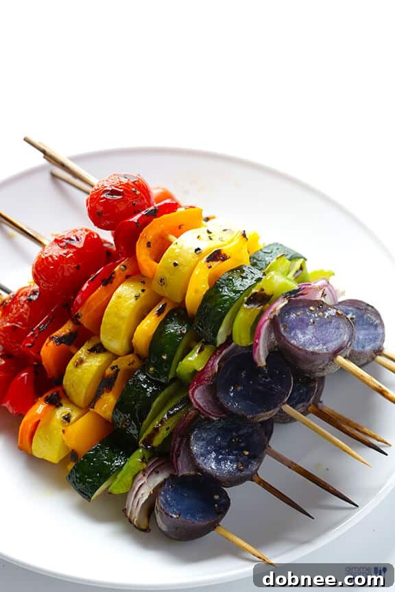 Close-up of vibrant red, orange, and yellow bell peppers on a rainbow veggie skewer