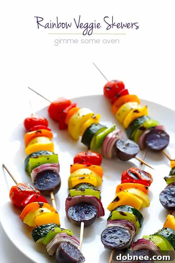 Platter of freshly grilled rainbow veggie skewers ready to be served outdoors