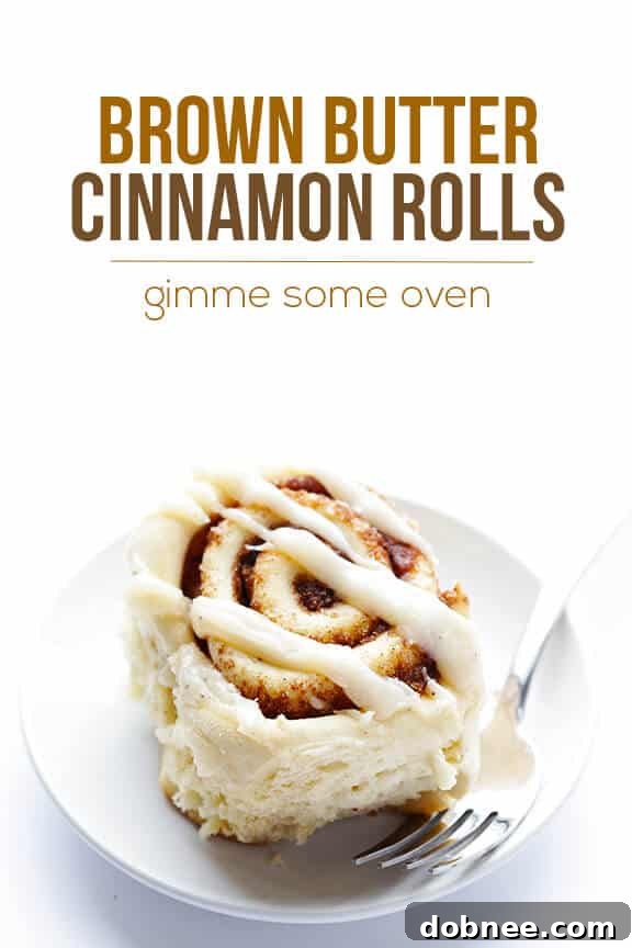A final, mouth-watering shot of a perfectly baked and frosted brown butter cinnamon roll.