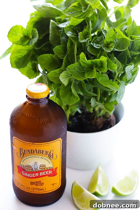 A bottle of Bundaberg Ginger Beer next to a fresh Ginger Beer Mojito, highlighting the recommended brand.