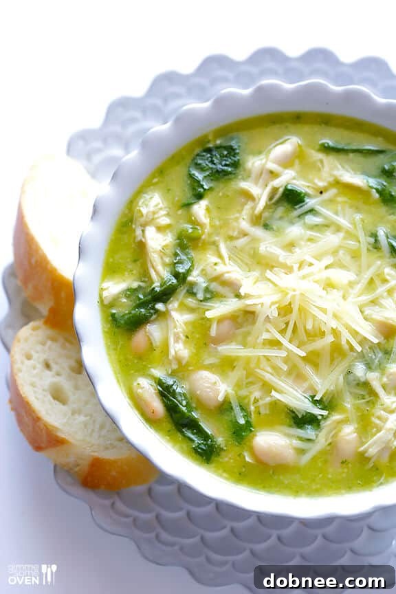 Adding pesto to the simmering 5-Ingredient Pesto Chicken Soup.