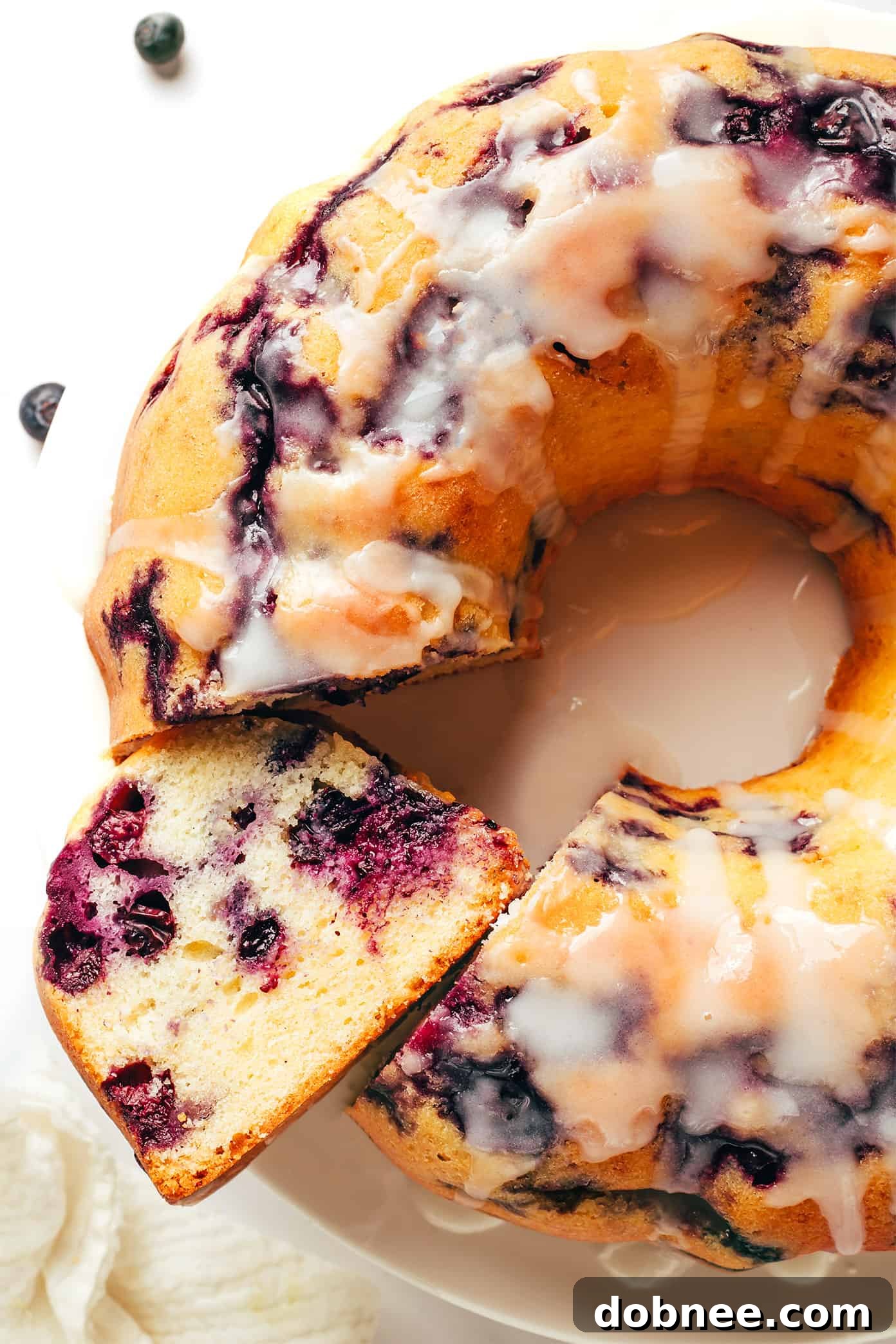 Another appealing image of the glazed blueberry bundt cake, whole and untouched, ready to be enjoyed.
