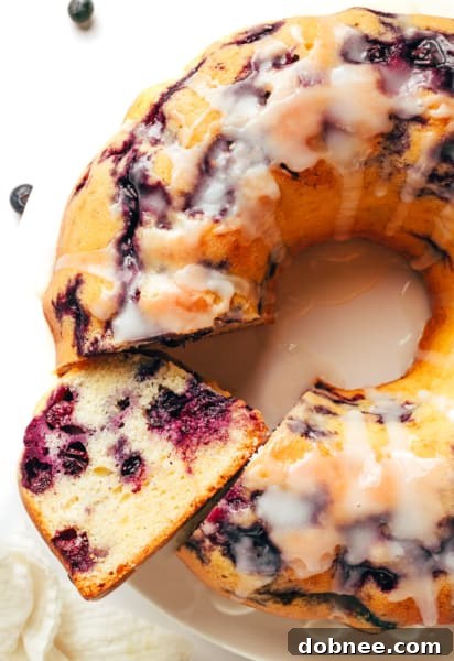 A high-angle shot of the baked blueberry cake, perfectly golden, with glaze drizzled on top, ready for serving.