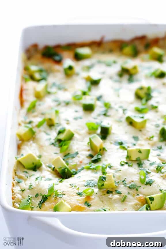 Freshly baked White Chicken Enchilada Casserole garnished with avocado and cilantro