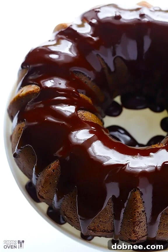 Rich chocolate glaze being drizzled over a Greek Yogurt Chocolate Cake