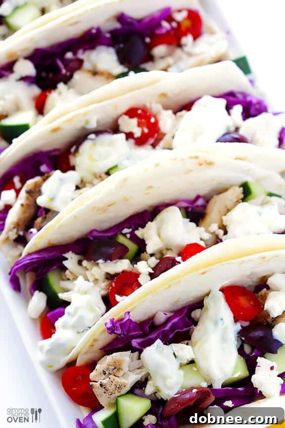 Finished Greek Fish Tacos served on a wooden board.