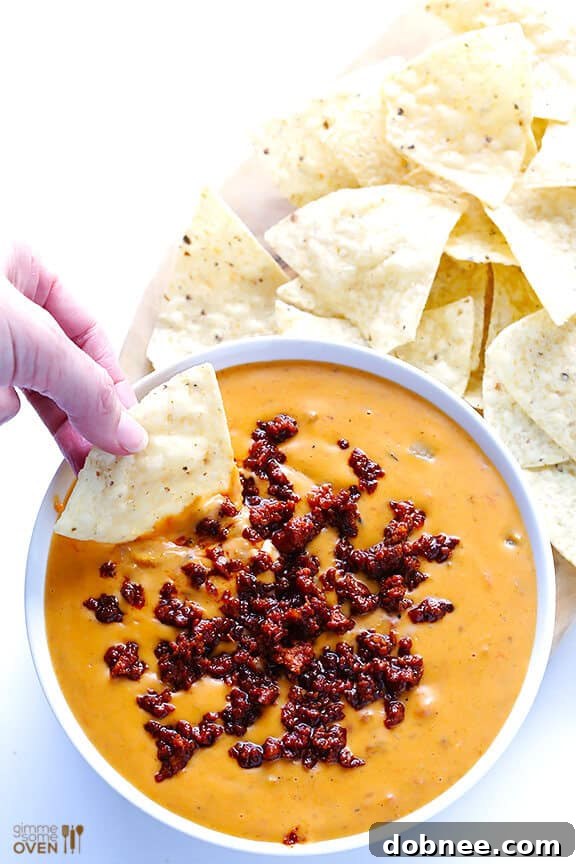 Mixing Crispy Chorizo into Creamy Queso Dip