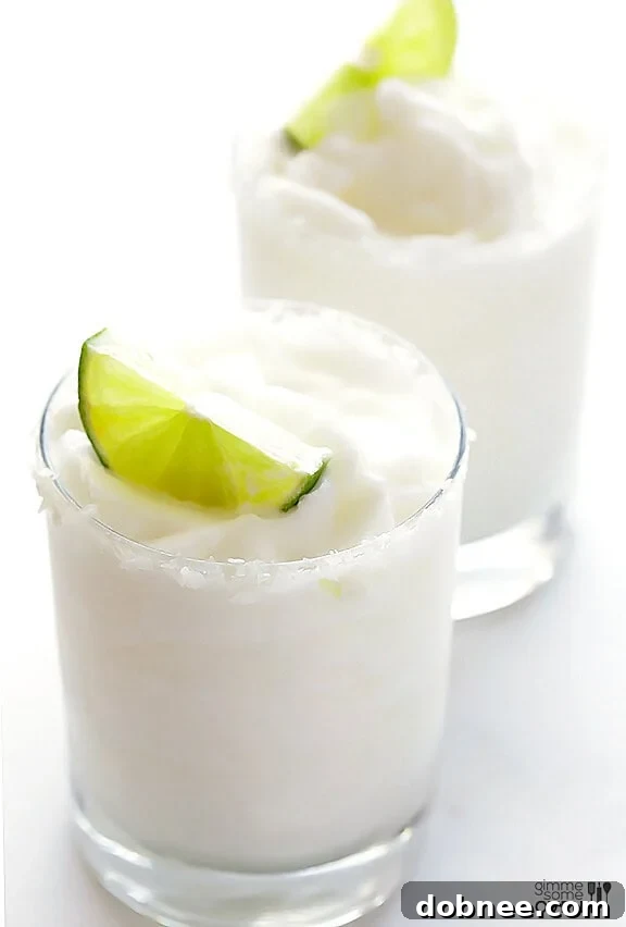 Refreshing Frozen Coconut Margarita with lime and shredded coconut garnish
