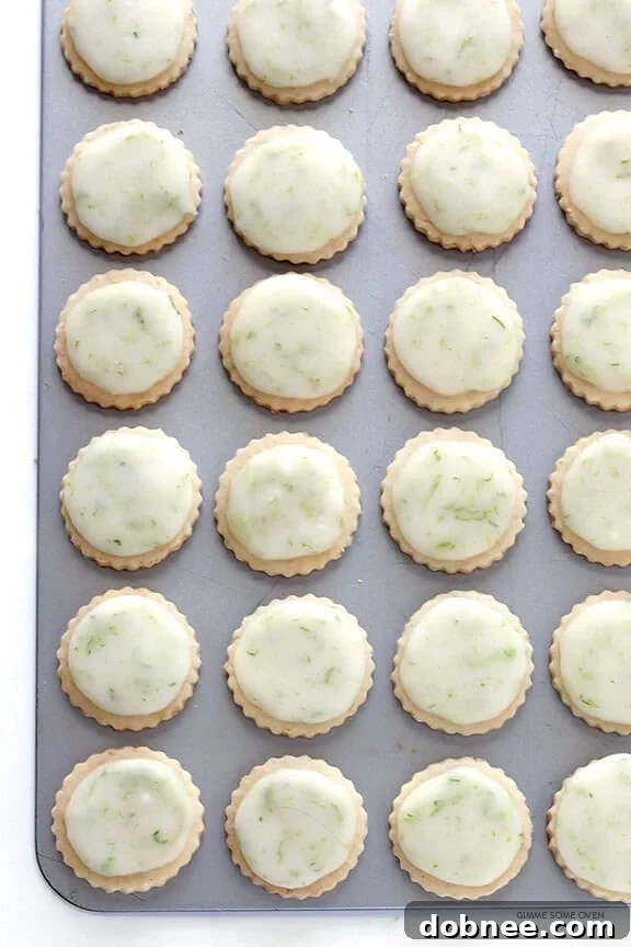 Coconut Lime Shortbread Cookies generously drizzled with a sweet lime glaze, highlighting their elegant finish.