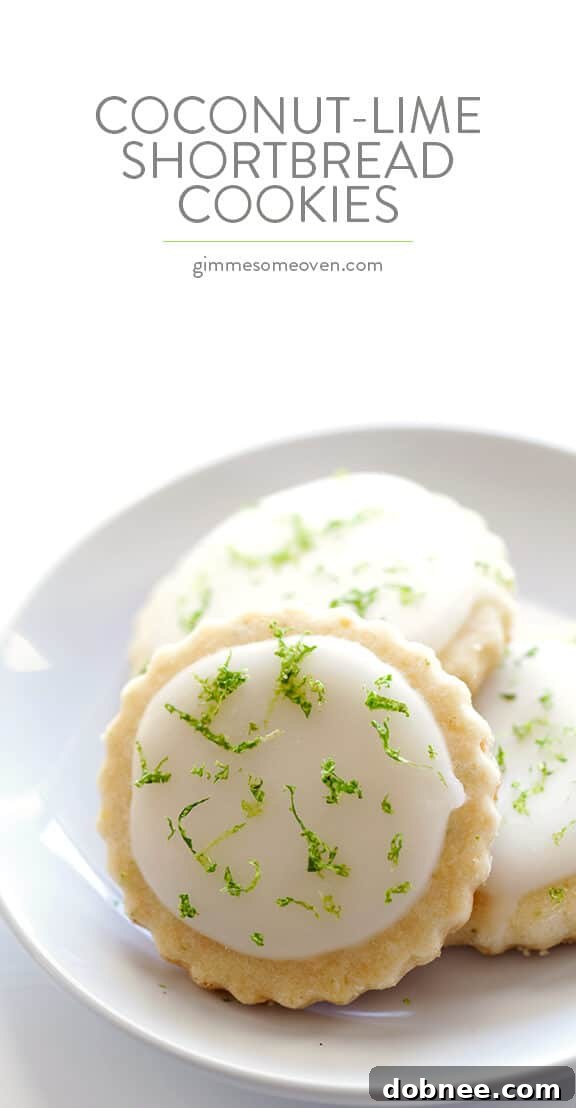 A beautifully composed photo of Coconut Lime Shortbread Cookies, showcasing their glazed finish and the fresh lime zest garnish.